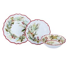 three white dishes with red trimming and holly wreaths on them, one is empty