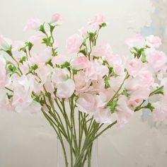 a vase filled with pink flowers on top of a table