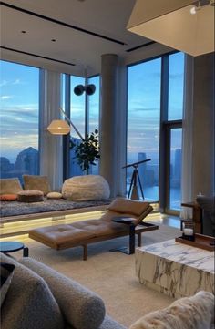 a living room filled with lots of furniture and large windows overlooking the cityscape