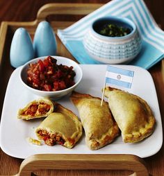 some food is sitting on a tray with bowls and utensils