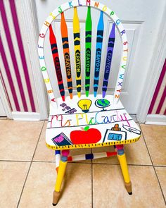 a wooden chair with crayons painted on it