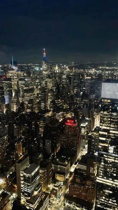 an aerial view of the city lights and skyscrapers in new york city at night