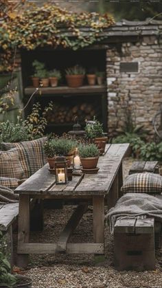 a wooden table sitting in the middle of a garden filled with plants and potted plants