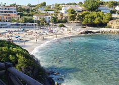 the beach is crowded with people and umbrellas