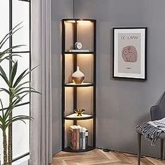 a living room filled with furniture next to a tall wooden book shelf on top of a hard wood floor