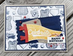 a close up of a birthday card on a wooden surface with the words celebrate written in red, white and blue