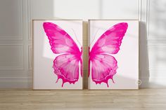 two pink butterfly paintings on the wall in an empty room