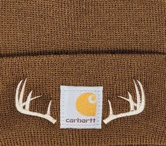 Carhartt TODDLER Acrylic Watch Hat embroidered with moose, deer or elk antlers on a Carhartt brown beanie for the little one in the family. When the temperature turns chilly, keep them warm by giving them the proper head cover. This hat is constructed from 100% acrylic with a stretchable rib knit to fit a toddler’s head. The woven Carhartt® label on the front shows a commitment to quality outdoor and hunting gear. Carhartt Embroidered Beanie, Hunting Embroidery, Bandana Embroidery, Beanie Embroidery, Embroidery Beanie, Boys Winter Hats, Carhartt Hat, Child Hat, Baby Boy Hat