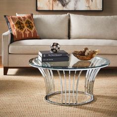 a living room with a couch, coffee table and pictures on the wall