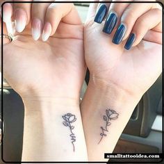 two women with matching tattoos on their arms holding each other's hands in the car