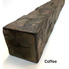 a close up of a wooden object on a white surface with the words coffee written below it