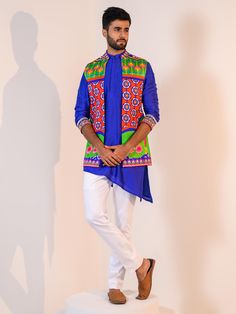 This Blue Asymmetrical Kurta Set with Veronica Half Jacket will instantly give an elegant look. This 3 piece kurta jacket set features a vibrant Veronica silk half jacket with heavy floral print, a blue asymmetrical silk kurta with embroidered cuffs of thread sequence work using mirror-beads-stones, invisible front button placket, and a mandarin collar. It is paired with white slim-fit cotton pants. An ideal outfit for traditional occasions, and special events.

Size Chart For Men Blue Silk Kurta For Spring, Fitted Blue Outerwear For Designer Wear, Blue Fitted Outerwear For Designer Wear, Blue Printed Kurta For Spring, Blue Fitted Kurta For Spring, Spring Blue Printed Kurta, Blue Fitted Floral Print Kurta, Spring Designer Wear Blue Sets, Designer Spring Blue Set