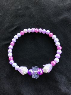 Purple and pink pearlescent beaded bracelet with bow for kids, teens and adults 18cm around  Show off your inner princess with this bracelet! Pink Pearl Bracelet For Party, Pink Pearl Party Bracelet, Party Pink Pearl Bracelet, Pink Pearl Beaded Bracelets For Parties, Pink Adjustable Pearl Stretch Bracelet, Adjustable Pink Pearl Stretch Bracelet, Pink Pearl Bracelet With Round Beads For Parties, Beaded Bracelet, Favorite Jewelry