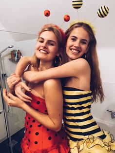 two girls hugging each other in the bathroom