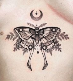 a woman's chest with a butterfly on it and an crescent in the middle