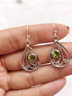 Teardrop shape  Sterling silver earrings studded  round facetted peridot cut stone   silver ear wire 92.5 purity 22*17*3mm approx size Gift jewelry Light weight earrings  Natural and beautiful gemstone  Healing  Green color Peridot Teardrop Earrings For May Birthstone, Teardrop Peridot Earrings For May Birthstone, Green Sterling Silver Teardrop Earrings, Green Peridot Teardrop Earrings, Silver Peridot Earrings For May Birthstone, Silver Peridot Drop Earrings, Silver Dangle Peridot Earrings, Silver Peridot Dangle Earrings, Green Pear-shaped Gemstone Earrings