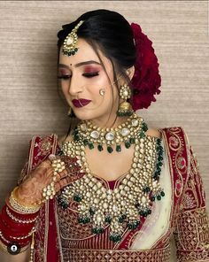 a woman with makeup and jewelry on her face