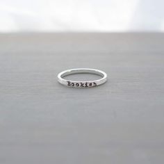 Get ready to step up your bookish goodies game! Here's the "Bookish" Sterling Silver Ring you're going to want to reach for more often than the book itself! Calling all the book lovers out there who cherish words as much as they do coffee (or wine, depending on the chapter)! This ring is your secret handshake into the elite society of book lovers, a token that silently screams your book lover status to the world. This handcrafted, minimalist beauty is a fine slice of sterling silver, just 2mm wi Book Ring, Secret Handshake, Book Rings, Starting A Book, Minimalist Beauty, Gifts For Bookworms, Let's Talk About, Let's Talk, Book Aesthetic