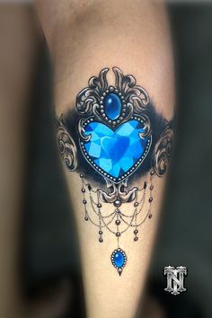 a blue heart tattoo on the leg