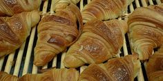 many croissants are lined up on the grill and ready to be cooked