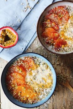 two bowls filled with food on top of a wooden table