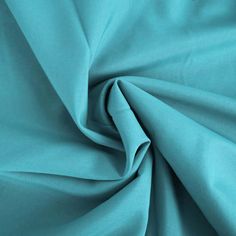 a close up view of the fabric in turquoise blue color, with very thin folds