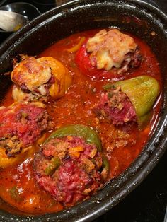 some stuffed peppers are in a pot on the stove