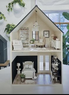 a doll house with furniture and plants in it