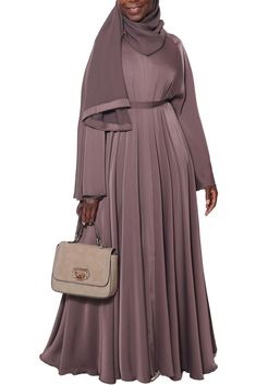 Stunningly gorgeous is how you will look in our lovely Dunya Abaya in Brown Sugar. Made with buttery-soft Nida fabric, Dunya is designed for simple, chic, elegance. The gorgeous A-line sweep gives you an amazing flow while the soft fabric glides beautifully across your skin. You will love this gorgeous piece for all your casual occasions. Made with luxuriously soft Korean Nida Open abaya with hidden buttons Matching shayla (scarf) included Model is 5'5 and is wearing size 58 Made in Dubai Cash App Card Ideas, Open Abaya, Garment Workers, Chiffon Sleeves, Simple Chic, Cash App, Over The Top, In Dubai, Brown Sugar