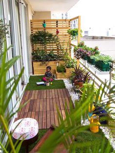 a small apartment balcony decorated with potted plants