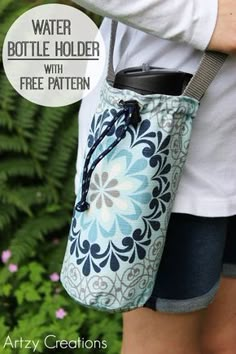 the water bottle holder with free pattern is shown in front of some plants and flowers