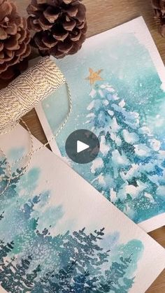 some pine cones are sitting on the table next to christmas cards and other holiday decorations