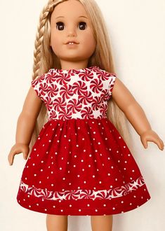 a doll with blonde hair wearing a red and white dress