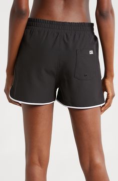 A '90s-inspired lace-up closure and dolphin hem bring some extra fun to these stretchy, high waist board shorts featuring built-in sun protection for the win. 2 1/2" inseam Zip fly with snap closure; lace-up closure Front slant pockets; back patch pocket with drainage grommet UPF 50+ sun protection 92% recycled polyester, 8% spandex Machine wash, tumble dry Imported Summer Swim Trunks With Built-in Shorts And Adjustable Waist, Summer Swim Trunks With Adjustable Waist And Built-in Shorts, Adjustable Waist Sporty Swimwear, Sporty Swimwear With Adjustable Waist For Summer, Sporty Summer Swimwear With Adjustable Waist, Swim Trunks With Built-in Shorts And Adjustable Waist, Adjustable Waist Swim Trunks With Built-in Shorts, Sporty Swim Trunks With Built-in Shorts, Summer Swim Trunks With Adjustable Waist