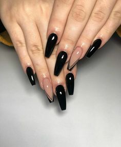 a woman's hands with black stiled nails and long, shiny nail polish