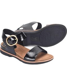 a pair of black sandals with gold buckles