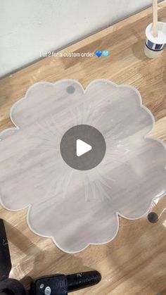 a video demonstrating how to make an acrylic flower design on a wood table