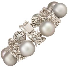 The Tahitian pearl and diamond cuff bracelet features eight large pearls (14.5mm) separated by eight floral motifs. The untreated pearls originate from the waters of French Polynesia. They display a beautiful nacre and their natural color and high luster have not been enhanced in any way. Their diameter is approximately 15mm. The interspersed floral motifs are set with a total of 4.00 carats of round diamonds of top quality (F/G-VVS). The bracelet is one-of-a-kind. It was entirely handmade in It Jewerly Bracelets, Diamond Cuff Bracelet, Pearl Cuff Bracelet, Diamond Bracelet Design, Pearl Jewels, Metal Cuff Bracelet, Modern Bracelets, Tahitian Black Pearls, Bracelet Design