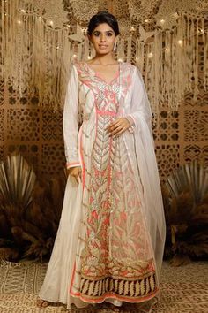 Ivory embroidered, padded and lined anarkali with gota applique and hyderabadi gota.
Component: 1
Pattern: Embroidery
Type Of Work: Gota applique work
Neckline: V Neck
Sleeve Type: Long sleeves
Fabric: Chanderi, Raw Silk
Color: Ivory
Other Details: 
Weight approx (in kg): 4
Gota applique work
Note: The palazzo and dupatta shown in the image are not for sale
Occasion: Wedding - Aza Fashions V Neck Anarkali, Embroidered Anarkali, Applique Work, Pattern Embroidery, Indian Fashion Designers, Pernia Pop Up Shop, Color Ivory, Raw Silk, Pop Up Shop