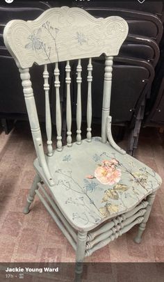 an old chair is upcycled into a new piece of furniture with flowers on it