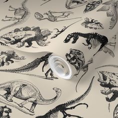 a wallpaper with dinosaurs in black and white on a light colored background that looks like wrapping paper