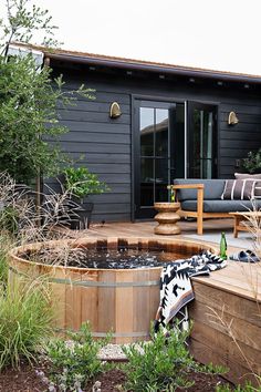 an outdoor living area with a large wooden tub