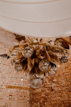 This is showing a hanging dried flower installation above a barn wedding dance floor. The installation is attached to a octagon hanging frame and has disco balls attached to it. Dance Floor Installation, Dried Flower Installation, Dance Floor Wedding, Flower Installation, Playful Style, Wall Candles, Pampas Grass, Floor Installation