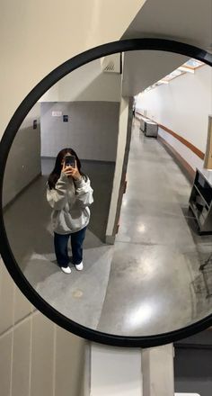 a woman taking a selfie in a mirror