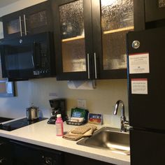 a black refrigerator freezer sitting inside of a kitchen