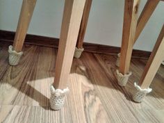 two wooden stools sitting on top of a hard wood floor next to each other