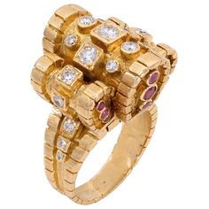 An early diamond, ruby, and 18-karat yellow gold cocktail ring by Ilias LALAoUNIS, Greece. This Ilias LALAoUNIS cocktail ring showcases a regal design with a combination of sparkling full and single-cut diamonds of an estimated 1-carat total weight and round-cut rubies weighing approximately .80 carats, carefully hand-set in 18 karat yellow gold. The brilliance of the diamonds and the rich allure of the rubies create a harmonious union, capturing the essence of timeless beauty and luxury. The intricate details of the gold work add an elegant touch, transforming the ring into a beauty that demands attention. Size 7: this ring is not resizable. Stamped: LALAoUNIS, 750. LALAoUNIS is famous for making expertly crafted Greek jewelry in high karat gold, drawing on ancient civilizations and seeki Gold Drawing, Yellow Gold Cocktail Ring, Gold Cocktail Ring, Greek Revival, Greek Jewelry, Gold Cocktail, Gold Work, Ancient Civilizations, Cocktail Ring