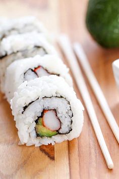 sushi with chopsticks on a wooden table