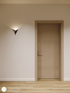 an empty room with two lights on the wall and a door in the middle that leads to another room