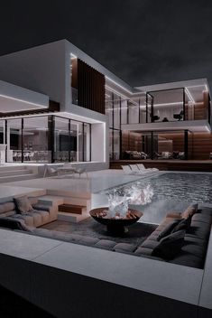 a modern house with a pool at night